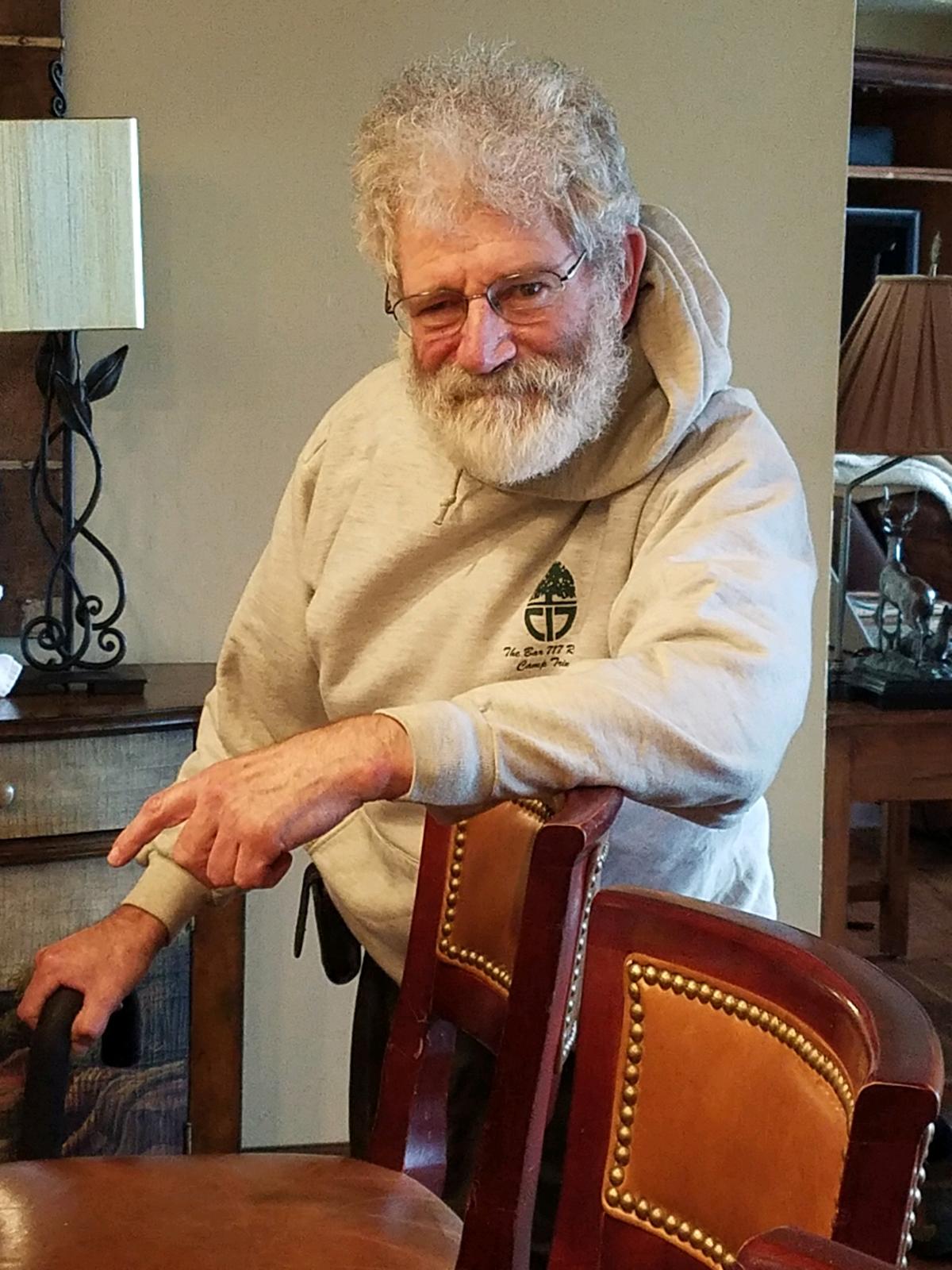 Eric leaning on a chair