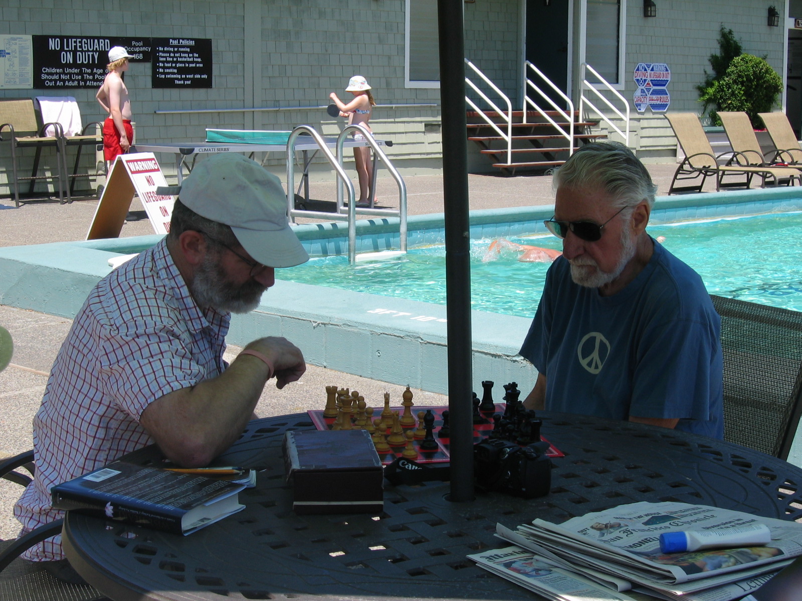 Eric & Peter play chess by a pool